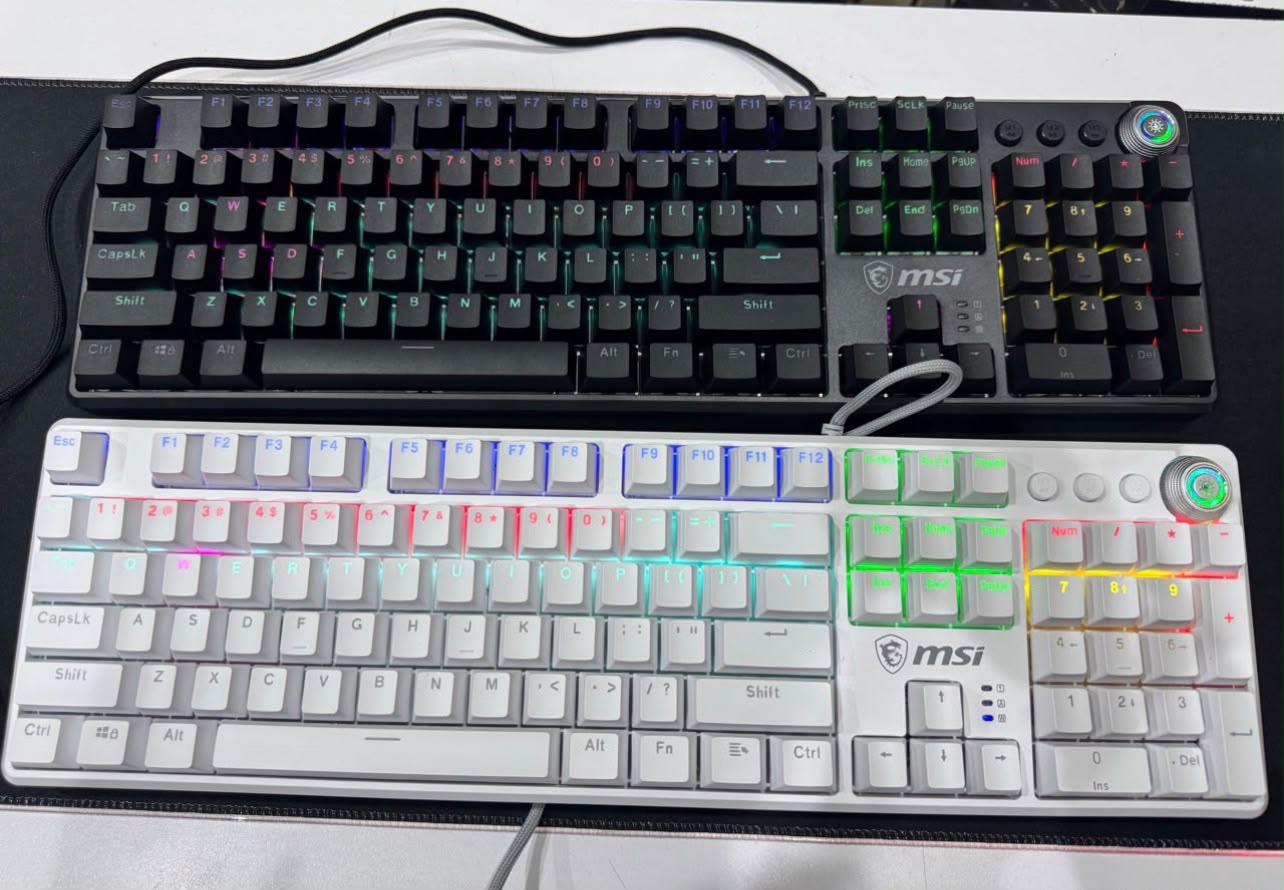 WE HAVE RESTOCKED THE MSI VIGOR GK50Z V2 MECHANICAL GAMING KEYBOARDS •Full-Size 104-Key Gaming Keyboard •Hot-Swappable Mechanical Switches •Red Linear / Blue Tactile Switch Options •20 RGB Lighting Effects •Multifunction Control Knob •3 Dedicated Macro Keys •6-Key & N-Key Rollover Support •Detachable Magnetic Top Cover •Includes 3 Spare Switches & Keycap/Switch Puller •Up to 60 Million Keystroke Lifespan •Wired USB Connection •1.8m Paracord Threaded Cable product photo
